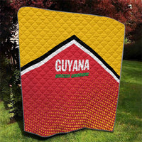 Square quilt showing yellow backing, red dotted panel, and GUYANA team crest in center