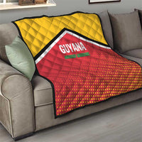 Quilt draped on a sofa: yellow top, red dotted bottom, black-and-white chevron, GUYANA