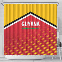 Yellow shower curtain on rod featuring Guyana text, Amazon Warriors logo, red dot pattern