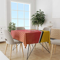 Red and yellow patterned cricket tablecloth with black trim on dining table