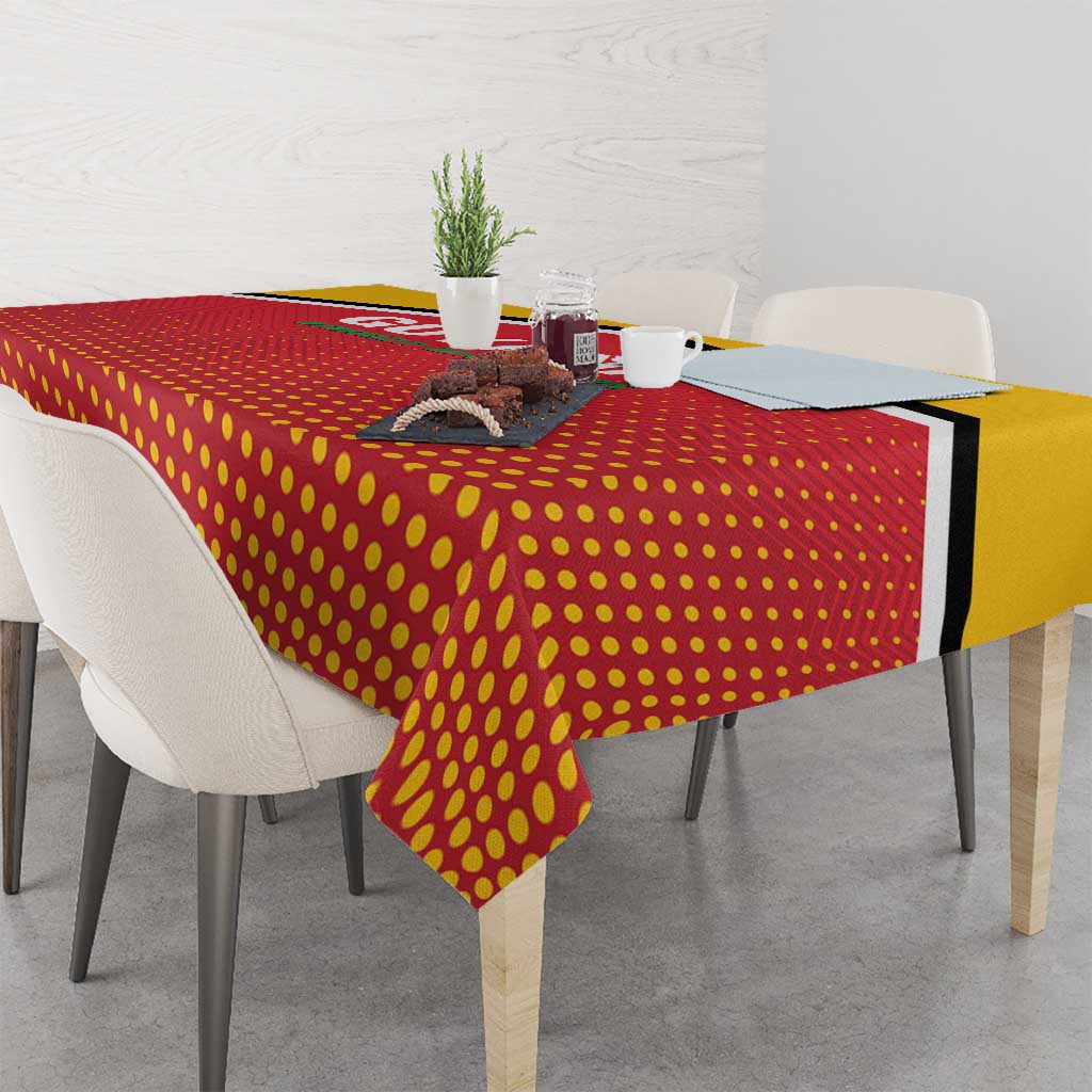 Red and yellow dotted cricket tablecloth with black edge, draped over table