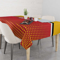 Red and yellow dotted cricket tablecloth with black edge, draped over table