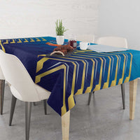 Blue tablecloth with gold chevron stripe design over table and chairs