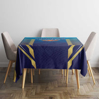 Blue dining tablecloth with gold geometric design displayed on round table