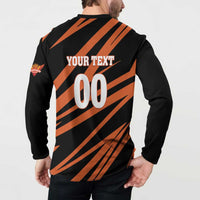 Back view: 'YOUR TEXT 00' on black and orange striped cricket button sweatshirt