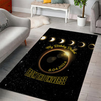Black area rug featuring golden eclipse rings, "My Birthday Present" and "FROM THE UNIVERSE"