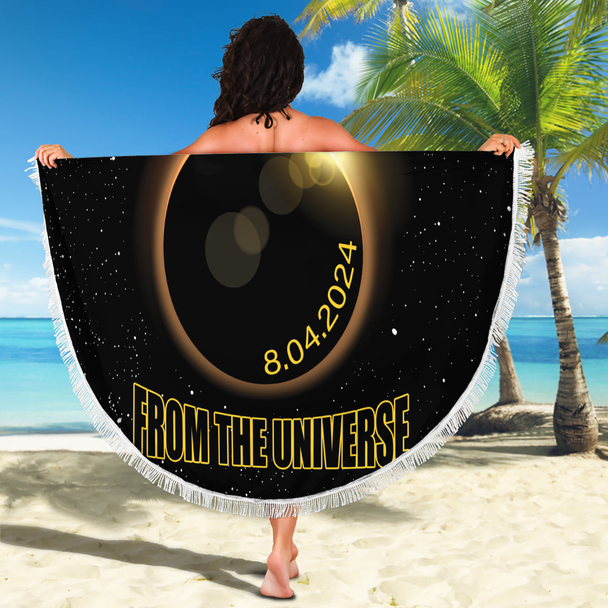 Black round beach blanket with white fringe, gold eclipse center, “From the Universe” banner text