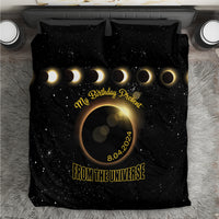 Black bedding set with starry eclipse graphic, gold text, and crescent moons on duvet