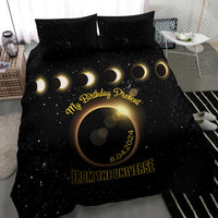 Black duvet bedding set with starry eclipse design, gold crescent moons, and date text