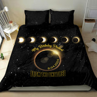Black bedding set featuring starry eclipse graphic, gold “FROM THE UNIVERSE” text