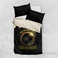 Black bedding set with starry eclipse artwork and gold “FROM THE UNIVERSE” lettering