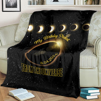 Black eclipse-themed throw blanket with gold text and crescent rings design
