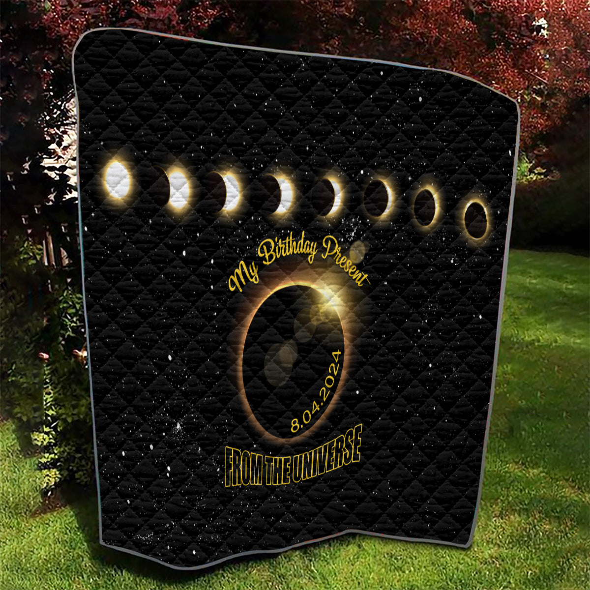 Black quilt with diamond stitching, glowing rings and eclipse emblem, '8.04.2024' text