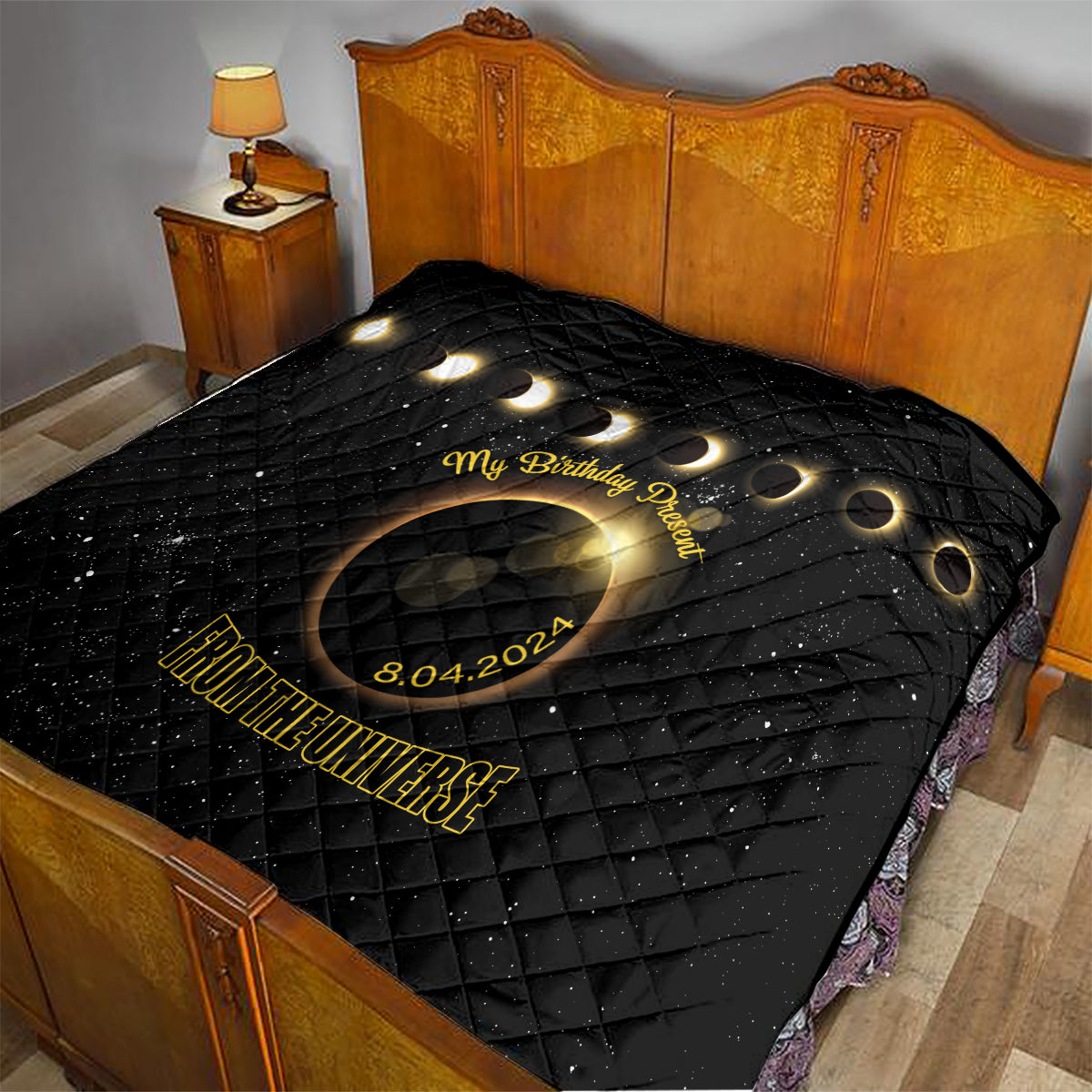 Black quilt with diamond stitching, golden eclipse design, 'My Birthday Present' and 'From the Universe'
