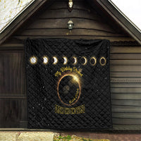 Black quilt with diamond stitching, golden eclipse emblem, rings, and '8.04.2024' date