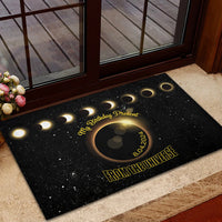 Black rubber doormat with glowing crescent eclipse graphic and “From the Universe”