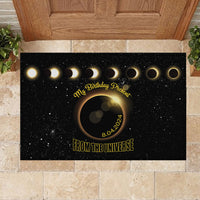 Black rubber doormat with eclipse rings, “My Birthday Present” script, and “From the Universe”