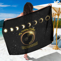 Black eclipse sarong with gold ring design and 'From the Universe' text