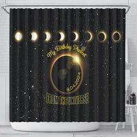 Black shower curtain with gold eclipse ring motif and 'FROM THE UNIVERSE' text