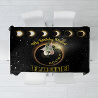 Black tablecloth with solar eclipse graphic, gold rings, and birthday message design