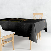 Black tablecloth draped on table edge, with solar eclipse gold-ring print