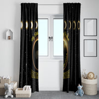 Black window curtain pair with gold eclipse art and moon phases, hanging over doorway