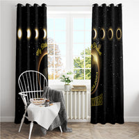 Black window curtain panels with gold eclipse circle and lettering, clipped to a top rod