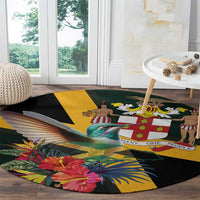 Round tropical area rug with black field, hummingbird, palm leaves, and hibiscus flowers