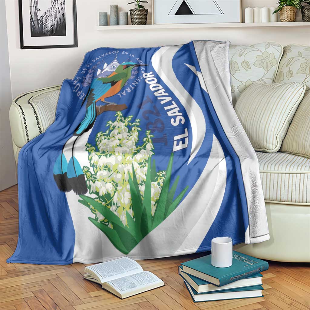 Blue and white decorative blanket with bird and flower graphic, El Salvador themed