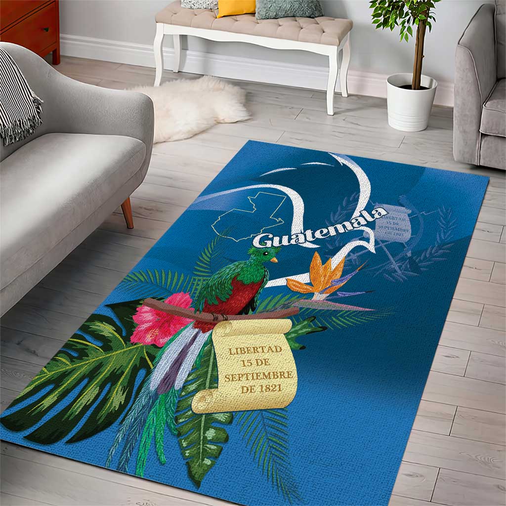Blue area rug with quetzal, flowers, and Guatemala crest with date plaque