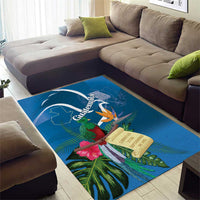 Blue area rug featuring quetzal, tropical leaves, and banner-style Guatemala graphic