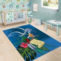 Blue area rug with quetzal, tropical flowers, and Guatemala banner design