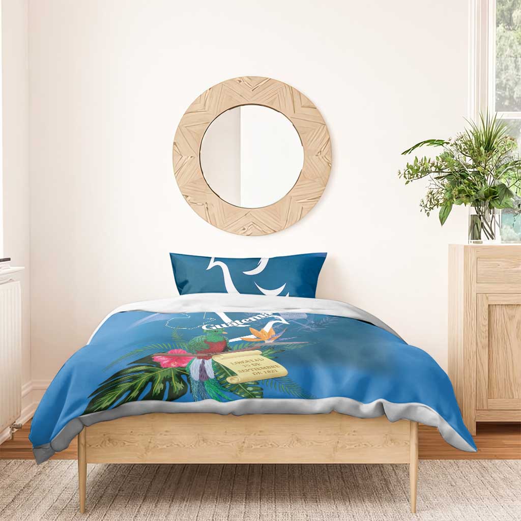 Blue bedding set with duvet and two pillows featuring quetzal and tropical flower print