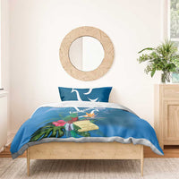 Blue bedding set with duvet and two pillows featuring quetzal and tropical flower print