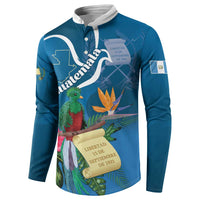 Blue henley sweatshirt with white collar and tropical bird, flower, and scroll graphic