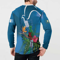 Blue henley sweatshirt worn by model, back graphic with quetzal, leaves, and white outline