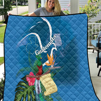 Blue quilt blanket with Quetzal, tropical flowers, and ribbon graphic with Guatemala text