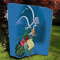 Blue quilt with Quetzal, tropical leaves and flowers, and Guatemala-themed emblem