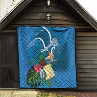 Blue quilt blanket with Quetzal, tropical blooms, and Guatemala ribbon design
