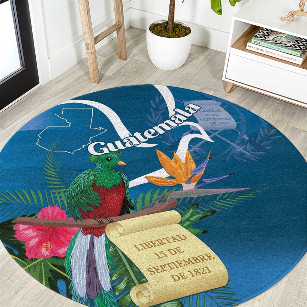 Blue round carpet with Quetzal bird, orange flower, and Libertad 15 de septiembre scroll
