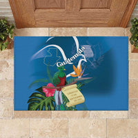 Blue rubber doormat featuring Guatemala crest, tropical leaves, bird, and flowers