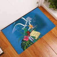 Blue rubber doormat with Guatemala wordmark, quetzal, tropical leaves, and flowers