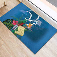 Blue rubber doormat with Guatemala crest, tropical leaves, and ceremonial scroll emblem