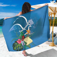 Blue sarong fabric spread out with quetzal, flowers, and decorative map graphic