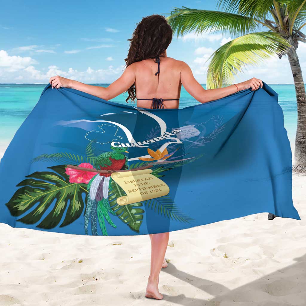 Blue tropical sarong with quetzal and floral border, draped across body from back