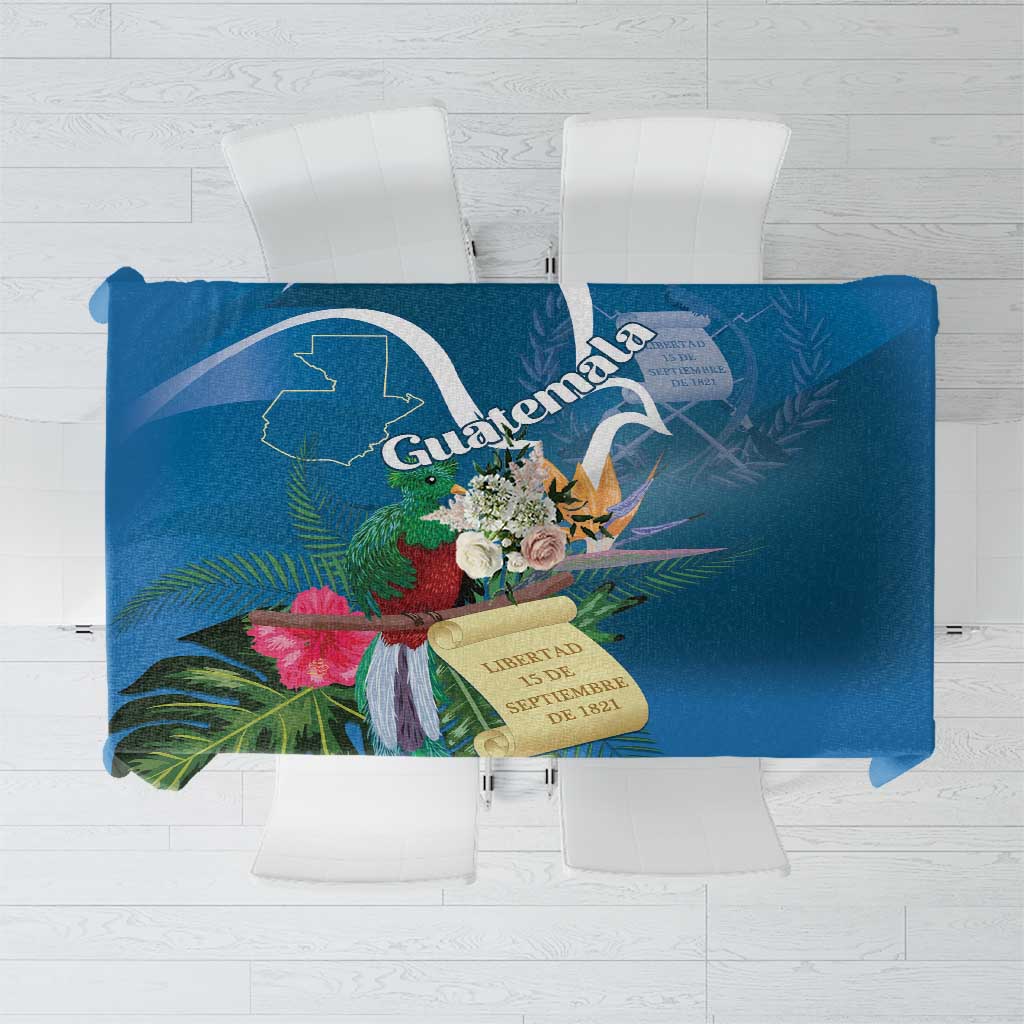 Blue tropical tablecloth with quetzal, floral accents, and “Guatemala” graphic center design.