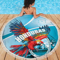 Round blue macaw beach blanket with white fringe, shown on poolside boards