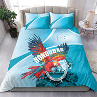 Sky blue bedding set with Honduras crest and bright scarlet macaw graphic on duvet
