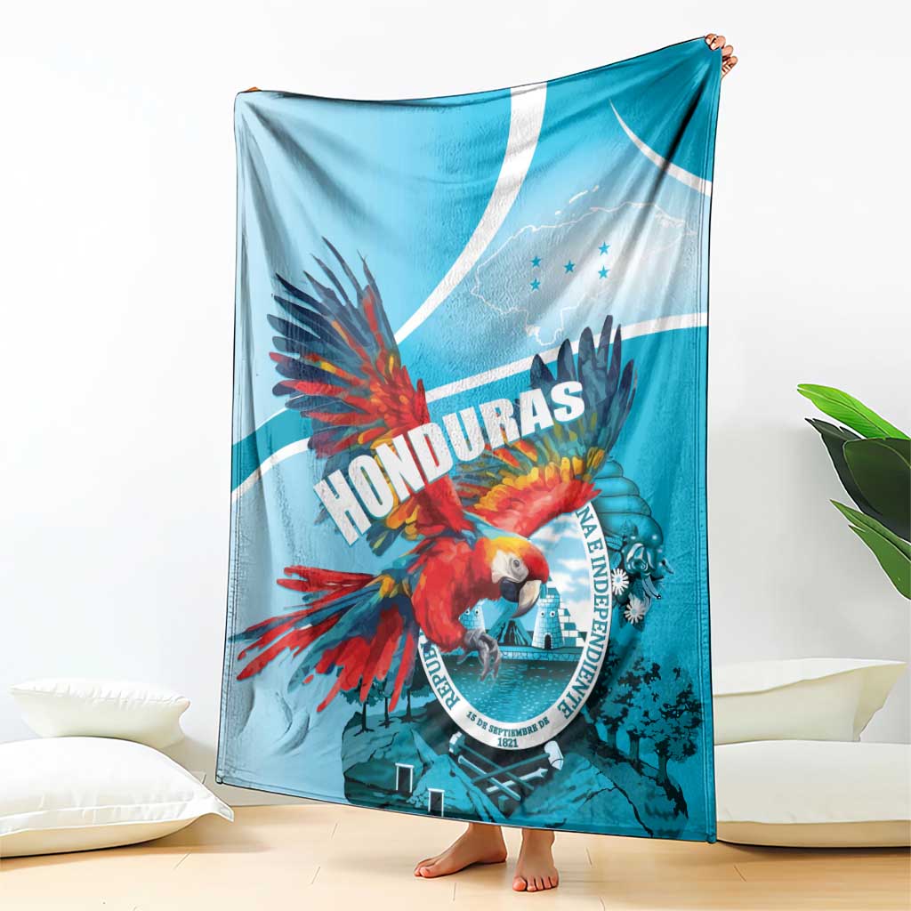 Sky blue Honduras throw blanket featuring red macaw, circular emblem, and white curved stripe.