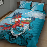 Sky blue quilt bed set with 2 pillows, macaw artwork and Honduras emblem in center